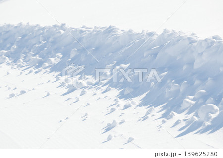 Curved edge of white snow on groomed ski slope Curved edge of white snow on groomed ski slope 139625280