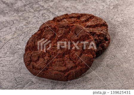 Stacked Dark Chocolate Cookies on Grey Textured Surface Stacked Dark Chocolate Cookies on Grey Textured Surface 139625431