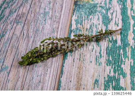 Fresh thyme sprig on rustic painted wooden background Fresh thyme sprig on rustic painted wooden background 139625446