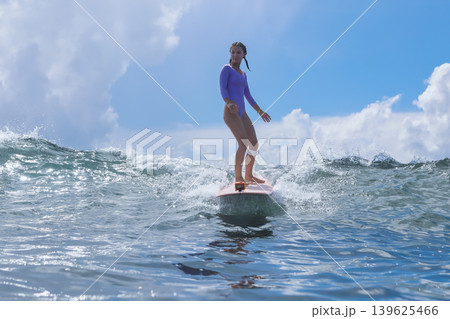 Young Lady With Composed Stance Amidst Peaceful Sea And Clear Sky Backdrop 139625466