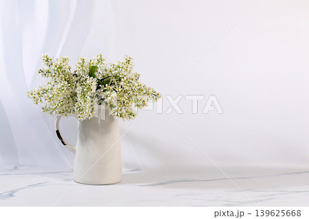 Abstract floral arrangement and banner for the screen. A still life with beautiful spring branches of blooming bird cherry in a vase against an elegant background. A floral holiday card Abstract floral arrangement and banner for the screen. A still life with beautiful spring branches of blooming bird cherry in a vase against an elegant background. A floral holiday card 139625668