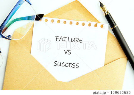 A white paper with FAILURE VS SUCCESS written on it emerges from an open brown envelope 139625686