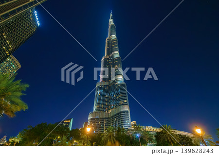 Dubai, United Arab Emirates - Jan 19 2024, panoramic view of the Burj Khalifa Tower from below, at nighttime with illumination and street lights, Dubai, UAE Dubai, United Arab Emirates - Jan 19 2024, panoramic view of the Burj Khalifa Tower from below, at nighttime with illumination and street lights, Dubai, UAE 139628243