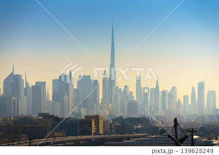 Dubai, United Arab Emirates - Jan 20 2024, panoramic skyline view of Dubai city downtown with skyscrapers, Burj Khalifa tower in center, in early morning in smoke and smog, Dubai, United Arab Emirates 139628249
