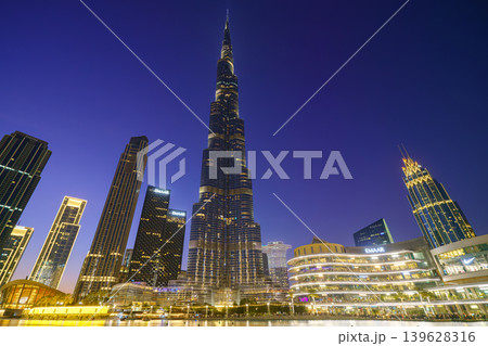 Dubai, United Arab Emirates - Jan 19 2024, panoramic view of the Burj Khalifa Tower from below, at nighttime with illumination and street lights, Dubai, UAE Dubai, United Arab Emirates - Jan 19 2024, panoramic view of the Burj Khalifa Tower from below, at nighttime with illumination and street lights, Dubai, UAE 139628316