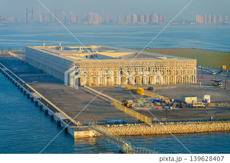 Doha, Qatar - Jan 14 2024, aerial sea view of new cruise terminal of Doha Port, with buildings and skyscrapers on background, at daytime, Doha, Qatar Doha, Qatar - Jan 14 2024, aerial sea view of new cruise terminal of Doha Port, with buildings and skyscrapers on background, at daytime, Doha, Qatar 139628407