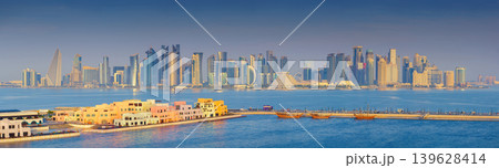 Doha, Qatar- Jan 14 2024, Panoramic view of the Mina District, part of the port of Doha and long pier, with skyscrapers and buildings in the background, at daytime, Doha, Qatar Doha, Qatar- Jan 14 2024, Panoramic view of the Mina District, part of the port of Doha and long pier, with skyscrapers and buildings in the background, at daytime, Doha, Qatar 139628414
