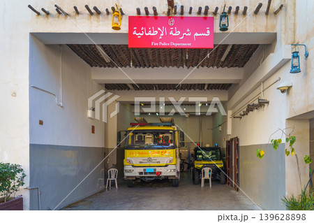Doha, Qatar - Jan 14 2024, Panoramic view of the garage of the fire station with a yellow fire truck, a sign on top in Arabic, at daytime, in the Souq Waqif bazaar area, Doha, Qatar Doha, Qatar - Jan 14 2024, Panoramic view of the garage of the fire station with a yellow fire truck, a sign on top in Arabic, at daytime, in the Souq Waqif bazaar area, Doha, Qatar 139628898