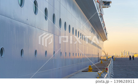 Doha, Qatar - Jan 14 2024, Panoramic view of the side of the moored MSC Virtuosa cruise ship and the dock, in the port of Doha, at evening, Doha, Qatar Doha, Qatar - Jan 14 2024, Panoramic view of the side of the moored MSC Virtuosa cruise ship and the dock, in the port of Doha, at evening, Doha, Qatar 139628911