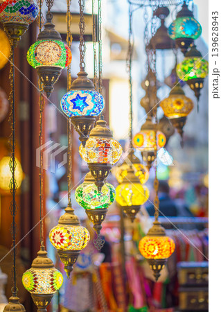 Manama, Bahrain- Jan 15 2024, Close-up view of multicolored antique glass lamps and lanterns with patterns, in souvenir shop, at Souq Bab Al Bahrain, the background is blurred, Manama, Bahrain  139628943