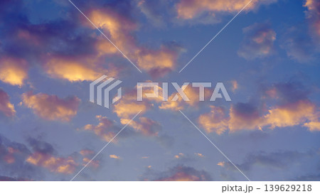 Panoramic view of colourful cumulus clouds against a blue sky at dawn 139629218