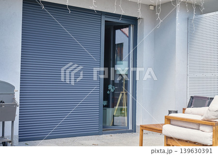Closed exterior roller shutter on modern patio window Closed exterior roller shutter on modern patio window 139630391