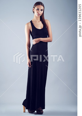 Portrait, fashion and confident woman in studio on gray background for elegant or classy style. Luxury, classic and clothing with beautiful young model in black dress outfit for formal event Portrait, fashion and confident woman in studio on gray background for elegant or classy style. Luxury, classic and clothing with beautiful young model in black dress outfit for formal event 139631205