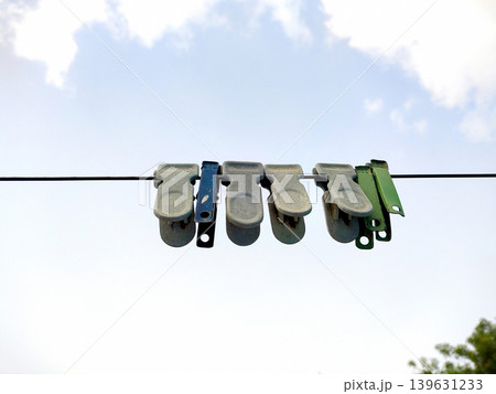 Colorful Clothespins Hanging on Laundry Line Outdoors 139631233