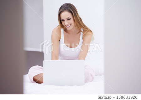 Woman, laptop and relax on bed for planning, search on website, online registration or home streaming. Happy and young person in bedroom with computer for morning news, social media update or blog Woman, laptop and relax on bed for planning, search on website, online registration or home streaming. Happy and young person in bedroom with computer for morning news, social media update or blog 139631920