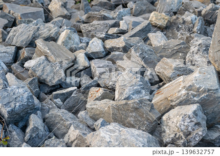Pile of gray stone rocks with rough natural texture and layered mineral surface ideal for construction geology and abstract background use 139632757