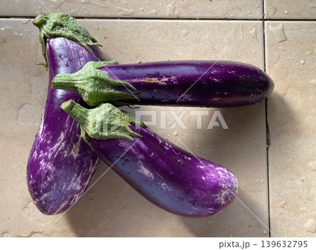 Three Fresh Purple Eggplants Solanum Melongena On Kitchen Countertop 139632795