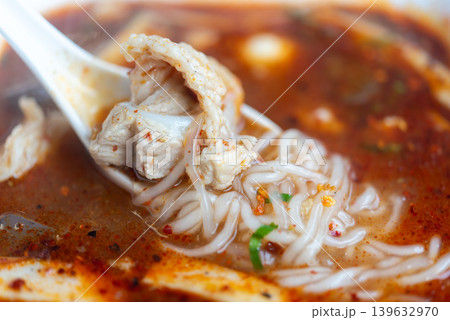 Vietnamese pork noodle soup with rich spicy broth tender meat and soft rice noodles served in traditional Asian style comfort food cuisine 139632970