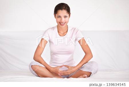 Smile, calm and portrait of woman with meditation for peace, zen and mindful wellness on bed. Happy, health and young female person in position for spiritual balance in bedroom at apartment. Smile, calm and portrait of woman with meditation for peace, zen and mindful wellness on bed. Happy, health and young female person in position for spiritual balance in bedroom at apartment. 139634545