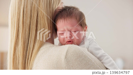 Comfort, mother and a crying newborn for love, care and sad in the morning. House, family and a young mom or woman with affection, support and holding a baby, child or kid for sleep, rest or tired Comfort, mother and a crying newborn for love, care and sad in the morning. House, family and a young mom or woman with affection, support and holding a baby, child or kid for sleep, rest or tired 139634797