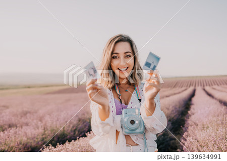Lavender woman photography capturing memories in a blooming purple flower meadow during a beautiful summer sunset Lavender woman photography capturing memories in a blooming purple flower meadow during a beautiful summer sunset 139634991