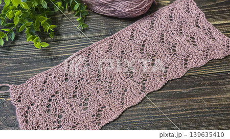 Knitting patterns with a raised pattern and yarn in different colors. Copy space Knitting patterns with a raised pattern and yarn in different colors. Copy space 139635410
