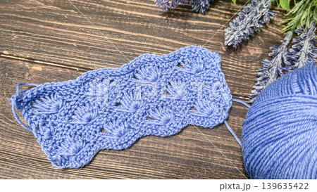 Knitting patterns with a raised pattern and yarn in different colors. Copy space Knitting patterns with a raised pattern and yarn in different colors. Copy space 139635422