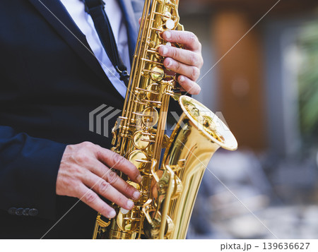 a man playing the saxophone a man playing the saxophone 139636627