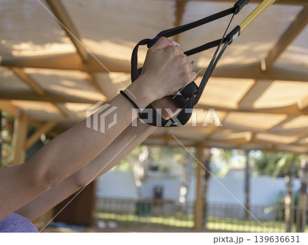 a woman exercising in the gym a woman exercising in the gym 139636631