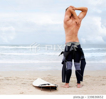 Back of surfer, man is stretching and beach, surfboard for ocean waves and start fitness, adventure and travel. Nature, vacation and surfing in Hawaii, summer holiday on an island and extreme sports 139636652