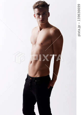 Portrait, natural and masculine with body of man in studio on white background for health or wellness. Aesthetic, beauty and skin with young shirtless model in jeans for hygiene and satisfaction 139636699