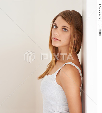Beauty, portrait and woman leaning on wall with natural makeup in white background of studio. Serious, model and glow on skin from cosmetics and skincare aesthetic with calm, confidence and pride Beauty, portrait and woman leaning on wall with natural makeup in white background of studio. Serious, model and glow on skin from cosmetics and skincare aesthetic with calm, confidence and pride 139636794