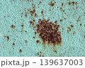 Large Rust Spot on Turquoise Metal Surface: Corroded Paint Texture with Brown Oxidation. Vintage Grunge Background 139637003
