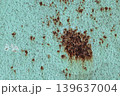 Large Rust Spot on Turquoise Metal Surface: Corroded Paint Texture with Brown Oxidation. Vintage Grunge Background 139637004