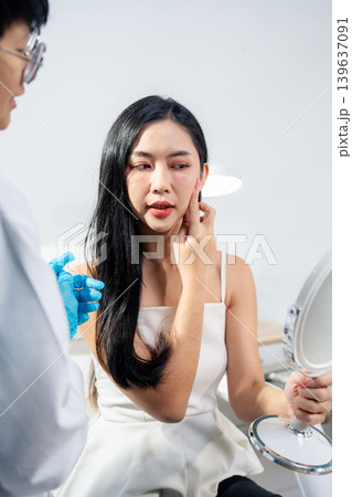 Asian woman consulting with a doctor at a modern aesthetic clinic for facial treatment. 139637091