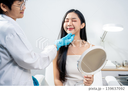 Asian woman consulting with a doctor at a modern aesthetic clinic for facial treatment. Asian woman consulting with a doctor at a modern aesthetic clinic for facial treatment. 139637092