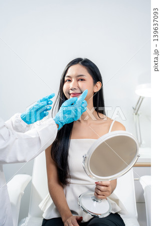 Asian woman consulting with a doctor at a modern aesthetic clinic for facial treatment. Asian woman consulting with a doctor at a modern aesthetic clinic for facial treatment. 139637093