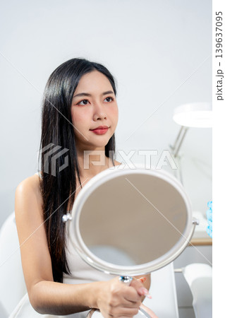 Asian woman consulting with a doctor at a modern aesthetic clinic for facial treatment. 139637095