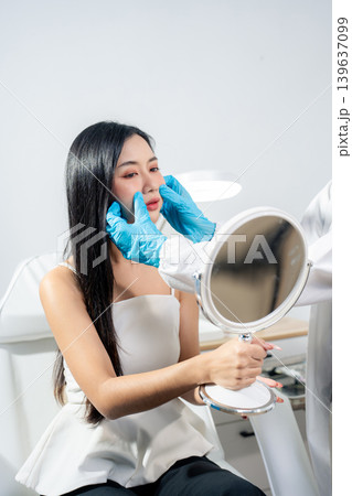 Asian woman consulting with a doctor at a modern aesthetic clinic for facial treatment. Asian woman consulting with a doctor at a modern aesthetic clinic for facial treatment. 139637099
