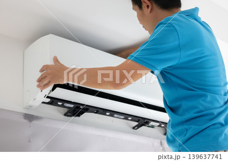 Electrician man repair and maintenance air conditioner 139637741