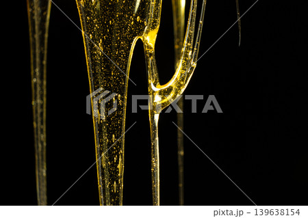 Creative honey swirl on black background. Creative honey swirl on black background. 139638154