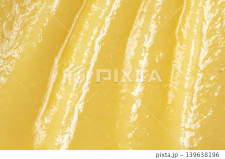 Macro texture of smooth golden apple puree surface. Macro texture of smooth golden apple puree surface. 139638196