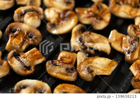 Roasted Champignon Mushroom Halves Close-up on Electric Grill Roasted Champignon Mushroom Halves Close-up on Electric Grill 139638213