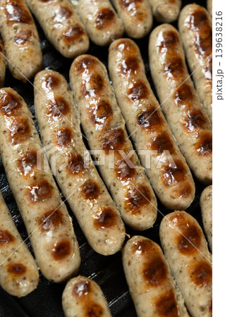 Batch of Sausages Roasting on Modern Electric Home Grill 139638216