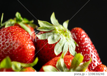 Ripe strawberries on dark background macro Ripe strawberries on dark background macro 139638240