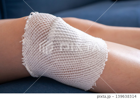 wound dressing bandage on child knee after fall on the ground wound dressing bandage on child knee after fall on the ground 139638314