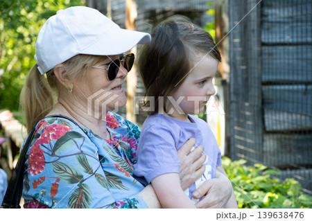Happy grandmother and grandchild spending time together in the zoo 139638476