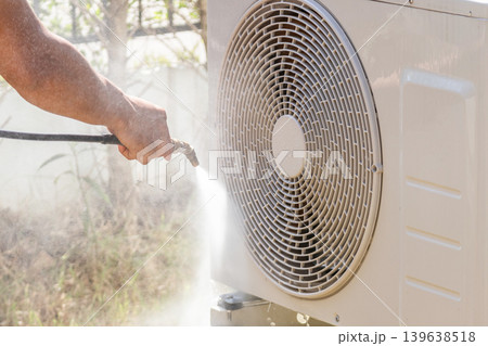 air conditioning compressor outdoor unit cleaning service with water spray 139638518