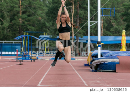 Female athlete triple jump 139638626
