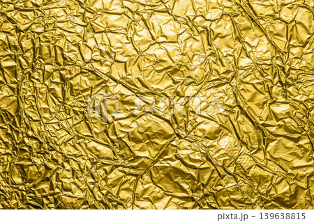 Luxury shiny metallic golden foil crumpled texture background Luxury shiny metallic golden foil crumpled texture background 139638815